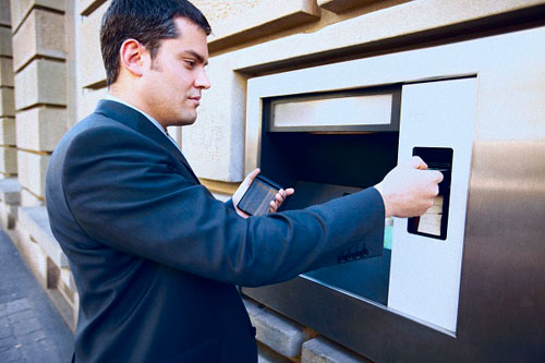 photo of man using ATM