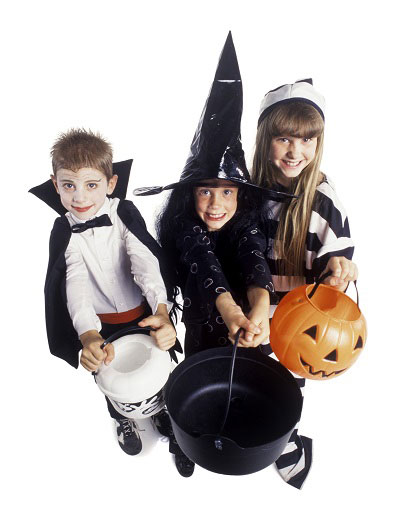 photo of three kids in halloween costume holding out trick or treat buckets