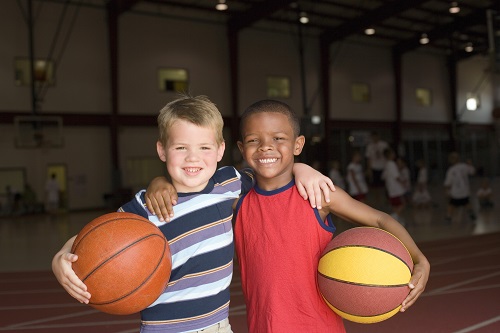 Two boys with basketballs in gym